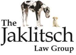 T he Jaklitsch Law Group logo, with a large black and white hound and a small yellow terrier