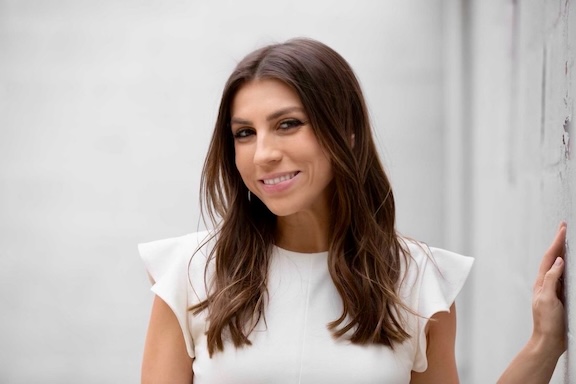 Brown haired woman in a white dress
