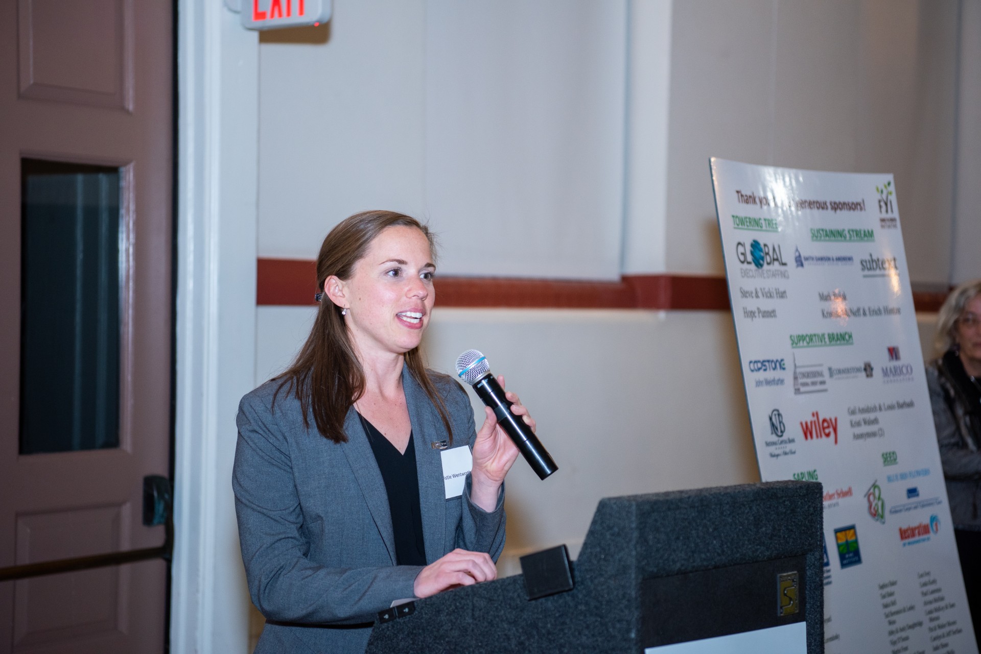 fyi volunteer Christie speaking at a podium
